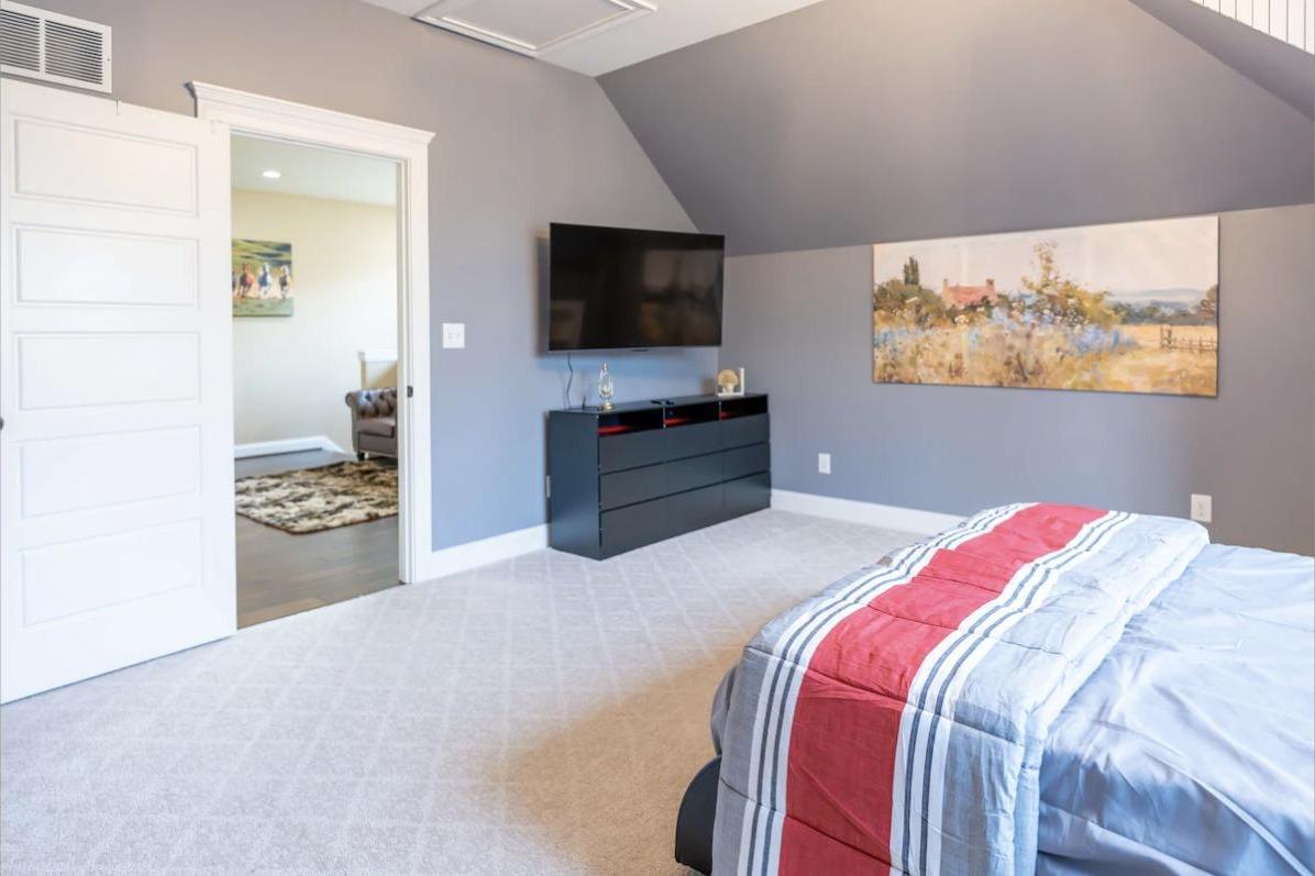 The Delphinium Suite, a contemporary queen bedroom with a floating bed