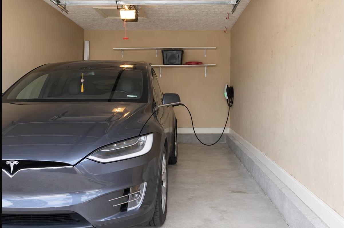 Garage reserved for EV charging with a Tesla connected