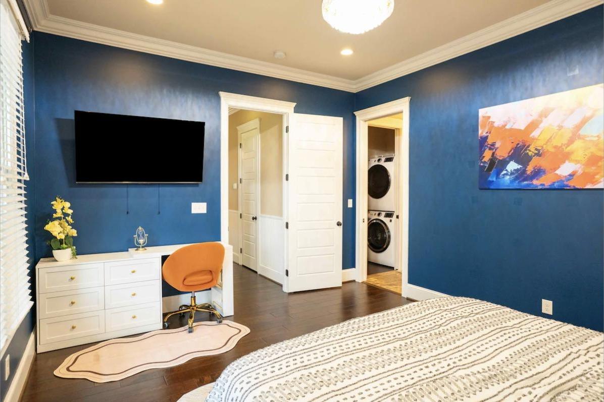 First-floor Primary Suite with king bed, workspace, and en-suite laundry