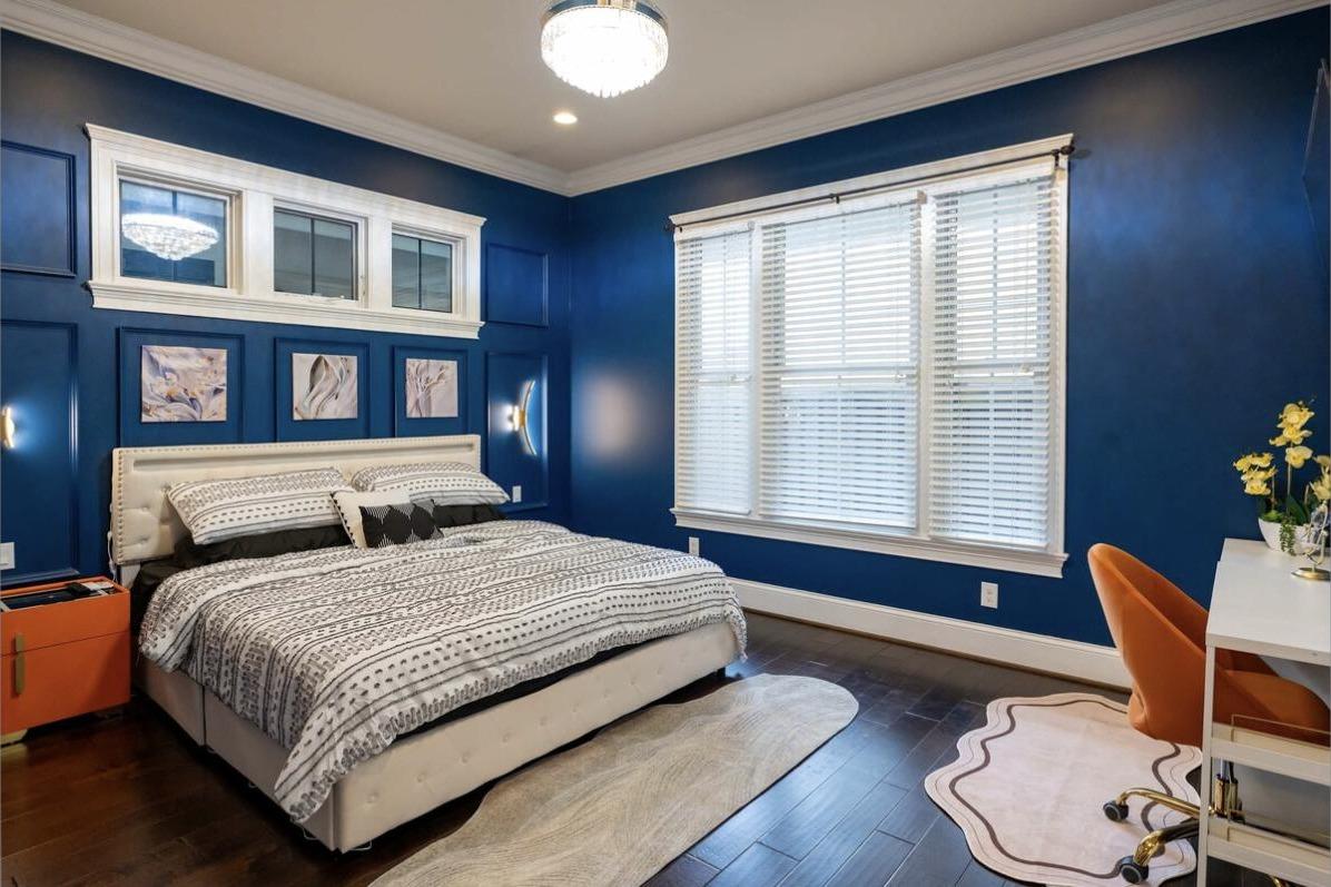 Primary Suite king bedroom with desk, nightstand safe, and full bath